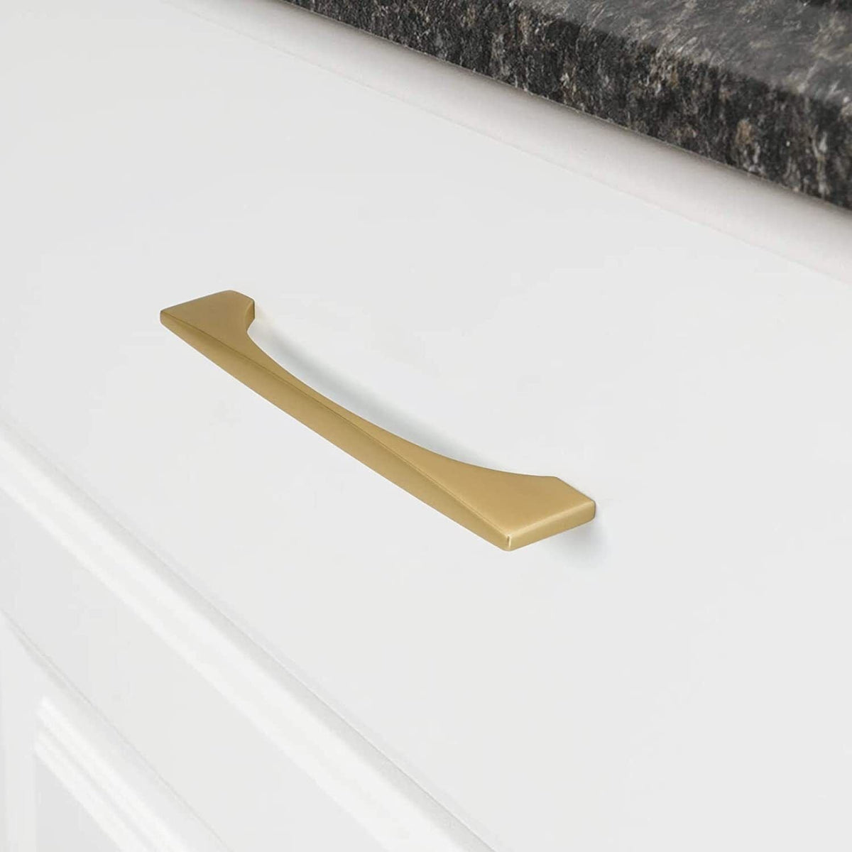 Gold arched aluminum cabinet pull, shown clearly in an installed cabinet close-up