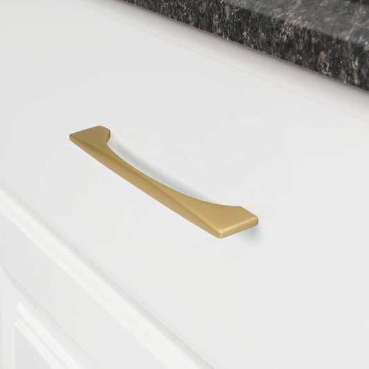Gold arched aluminum cabinet pull, shown clearly in an installed cabinet close-up
