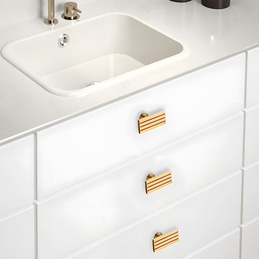 Gold art deco brass cabinet pull and knob, shown clearly installed on cabinetry in context