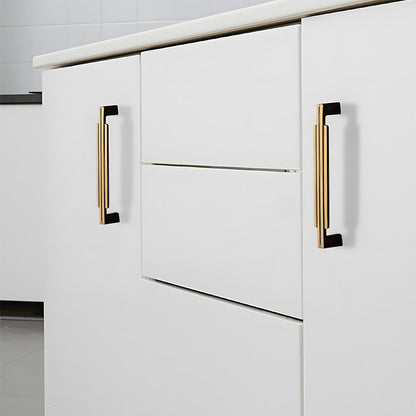 Art Deco brass cabinet pull and knob, pictured in one view installed on cabinetry in context