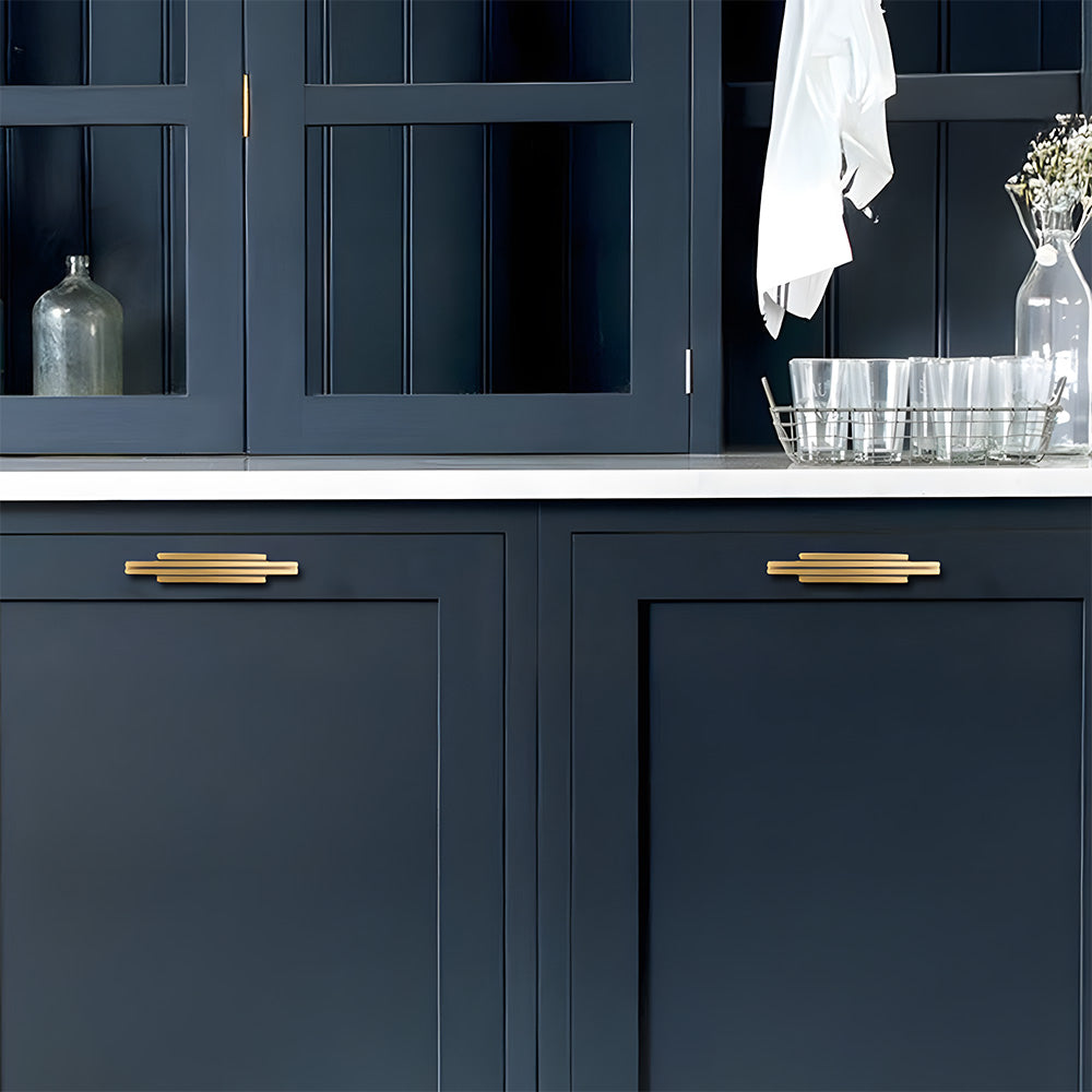 Antique bronze art deco brass cabinet pull and knob, presented for reference installed on cabinetry in context