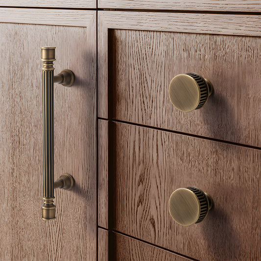 Art Deco fluted brass pulls, knobs, and ring pulls, shown clearly installed on cabinetry in context