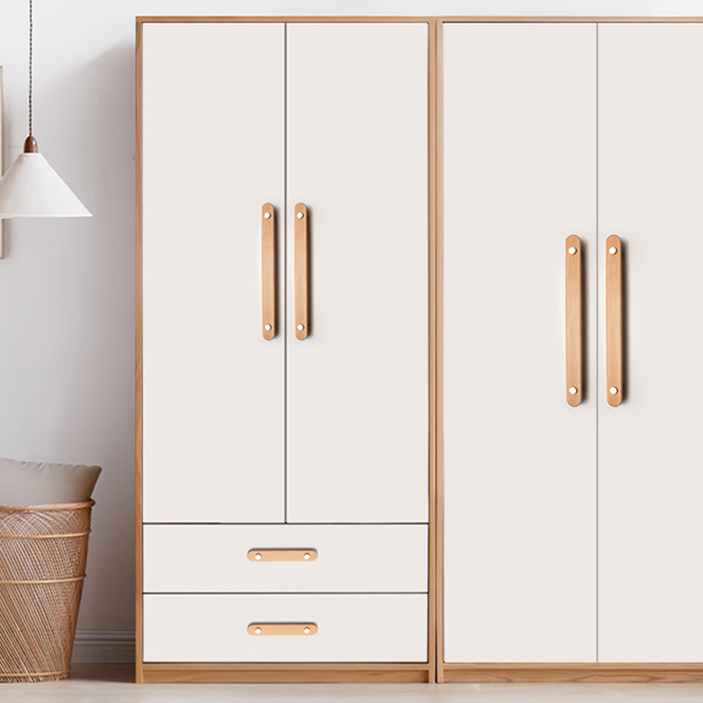 Wood drawer pull with copper accents in beech with 128 mm centers, installed vertically on paired wardrobe doors