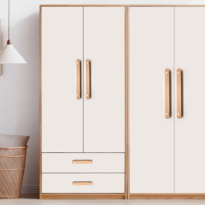 Wood drawer pull with copper accents in beech with 128 mm centers, installed vertically on paired wardrobe doors