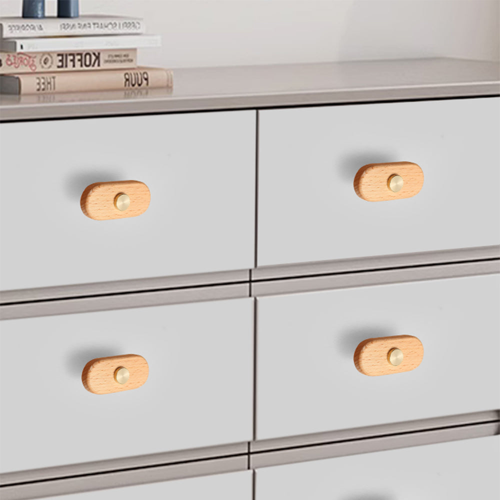 Beech-finish wood drawer pull with round copper accents, shown across several drawer fronts in a cabinet scene