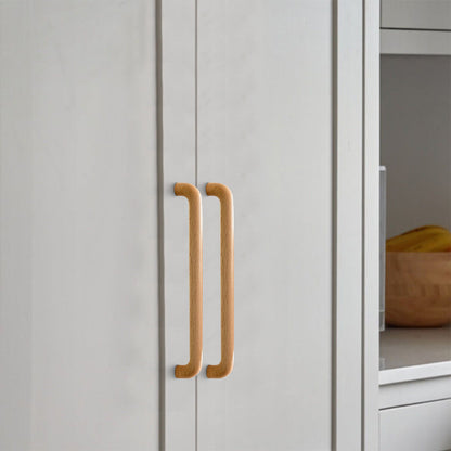 Beech wood cabinet pull in natural wood with 224 mm centers, installed on light cabinet doors with the profile visible