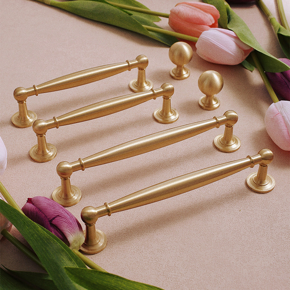 Brass round bar cabinet pull and round knob, shown clearly as a color and finish lineup