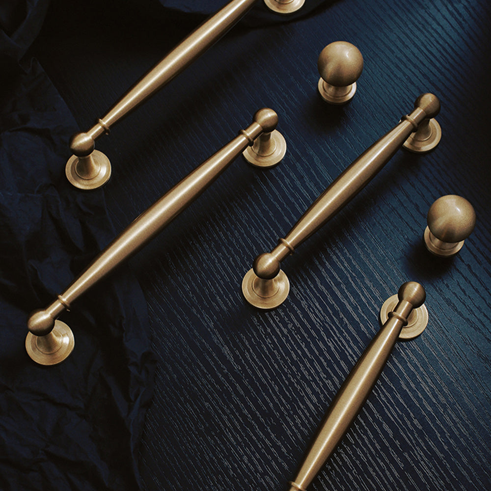 Brass round bar cabinet pull and round knob, pictured in one view as a color and finish lineup