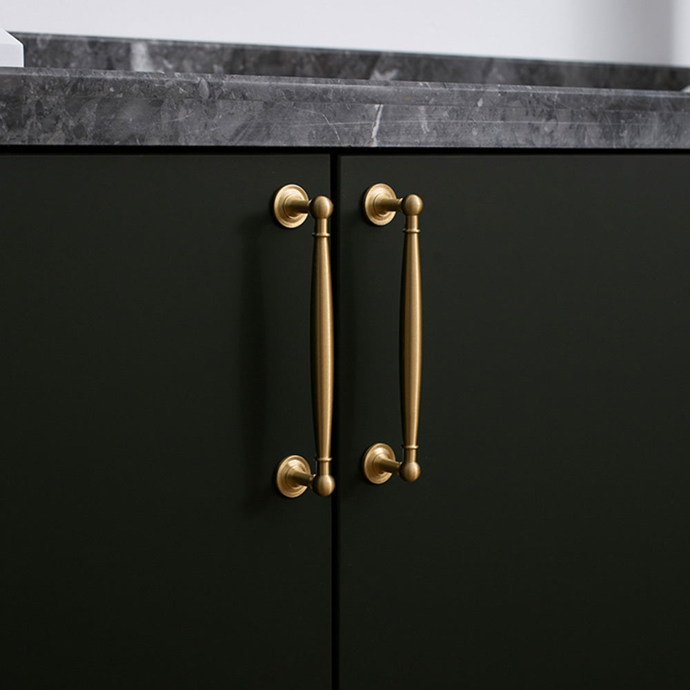 Gold brass round bar cabinet pull and round knob, pictured in one view installed on cabinetry in context