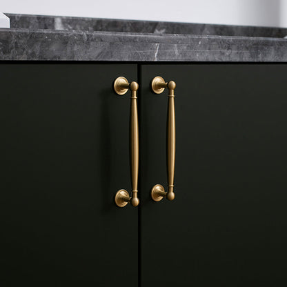 Gold brass round bar cabinet pull and round knob, pictured in one view installed on cabinetry in context