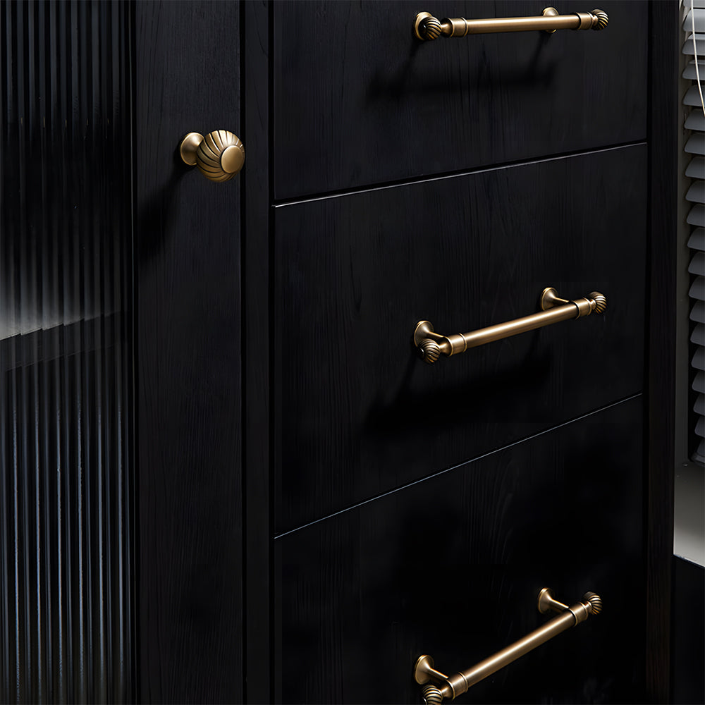 Bronze ribbed brass cabinet pull and shell knob, shown clearly installed on cabinetry in context