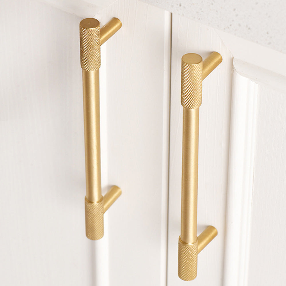 Knurled T-bar cabinet pull and round knob, shown from one angle in an installed cabinet close-up