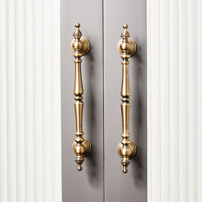 Bronze ornate brass cabinet pull and knob, shown from one angle in an installed cabinet close-up