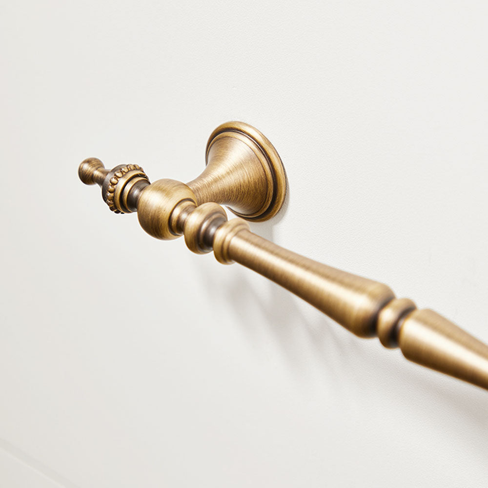 Ornate brass cabinet pull and knob, shown clearly with its construction and finish visible