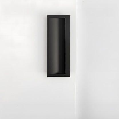 Black aluminum recessed cabinet pull with 96 mm hole centers installed vertically on a white door