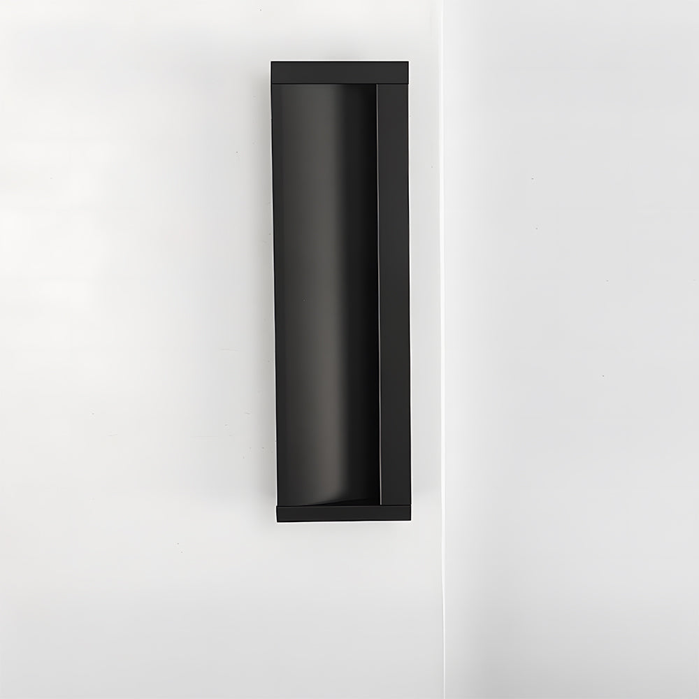 Black aluminum recessed cabinet pull with 128 mm hole centers installed vertically on a white door
