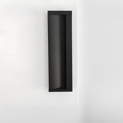 Black aluminum recessed cabinet pull with 128 mm hole centers installed vertically on a white door