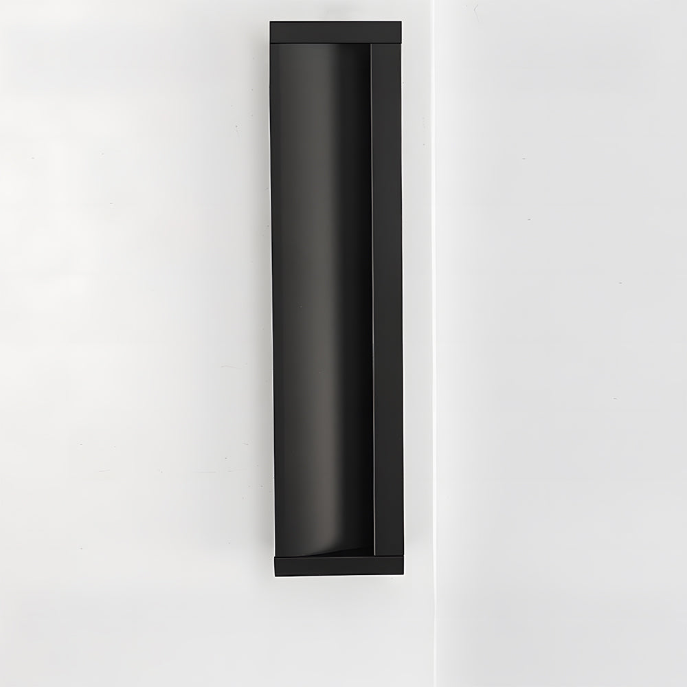 Black aluminum recessed cabinet pull with 160 mm hole centers installed vertically on a white door