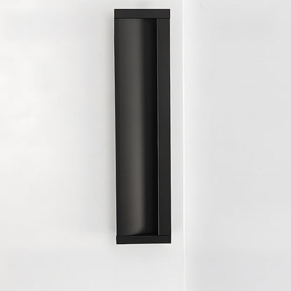 Black aluminum recessed cabinet pull with 160 mm hole centers installed vertically on a white door