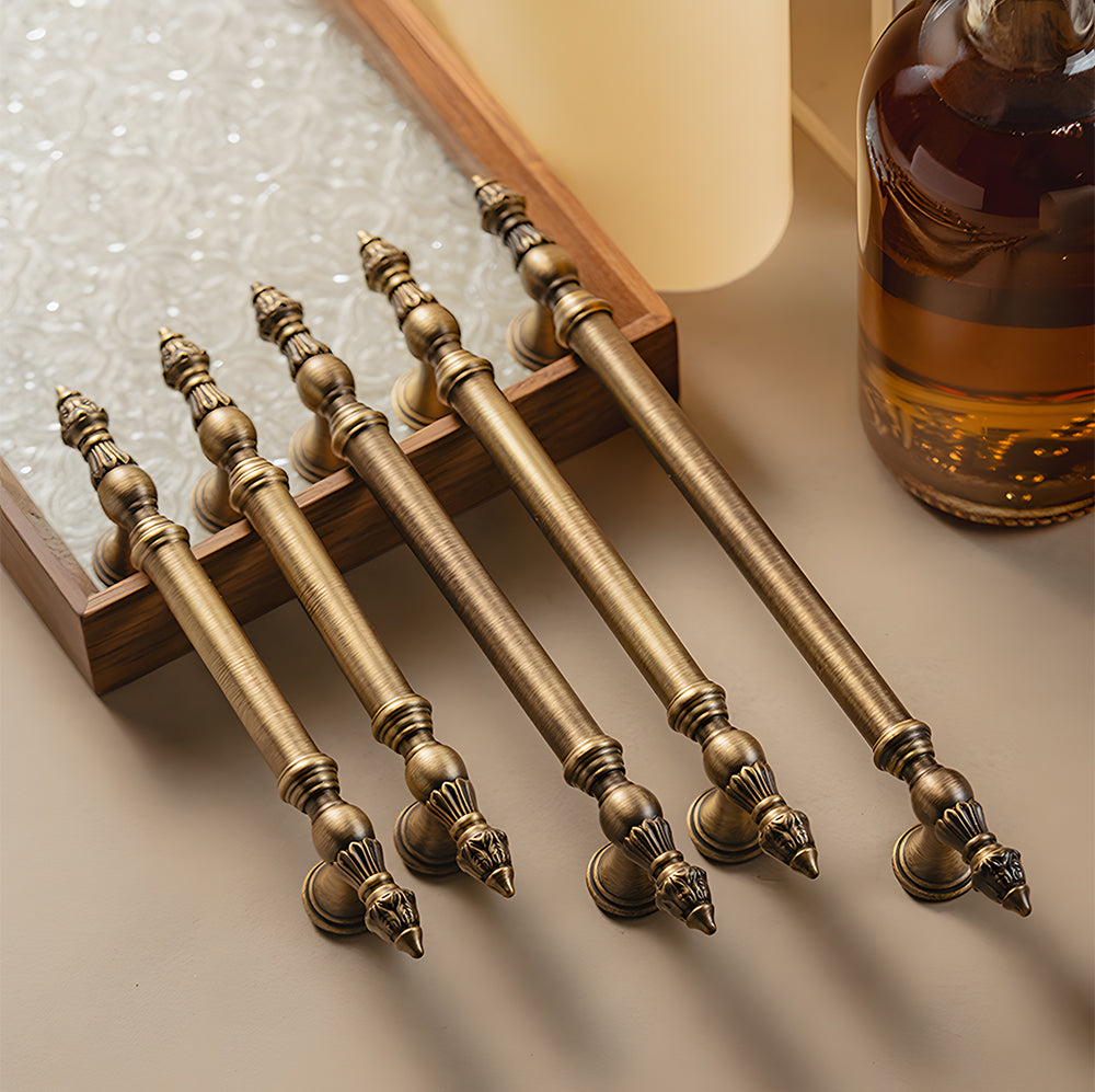 Ornate european brass cabinet pull and round knobs, presented for reference with related hardware in one display