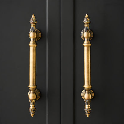 Ornate european brass cabinet pull and round knobs, pictured in one view installed on cabinetry in context