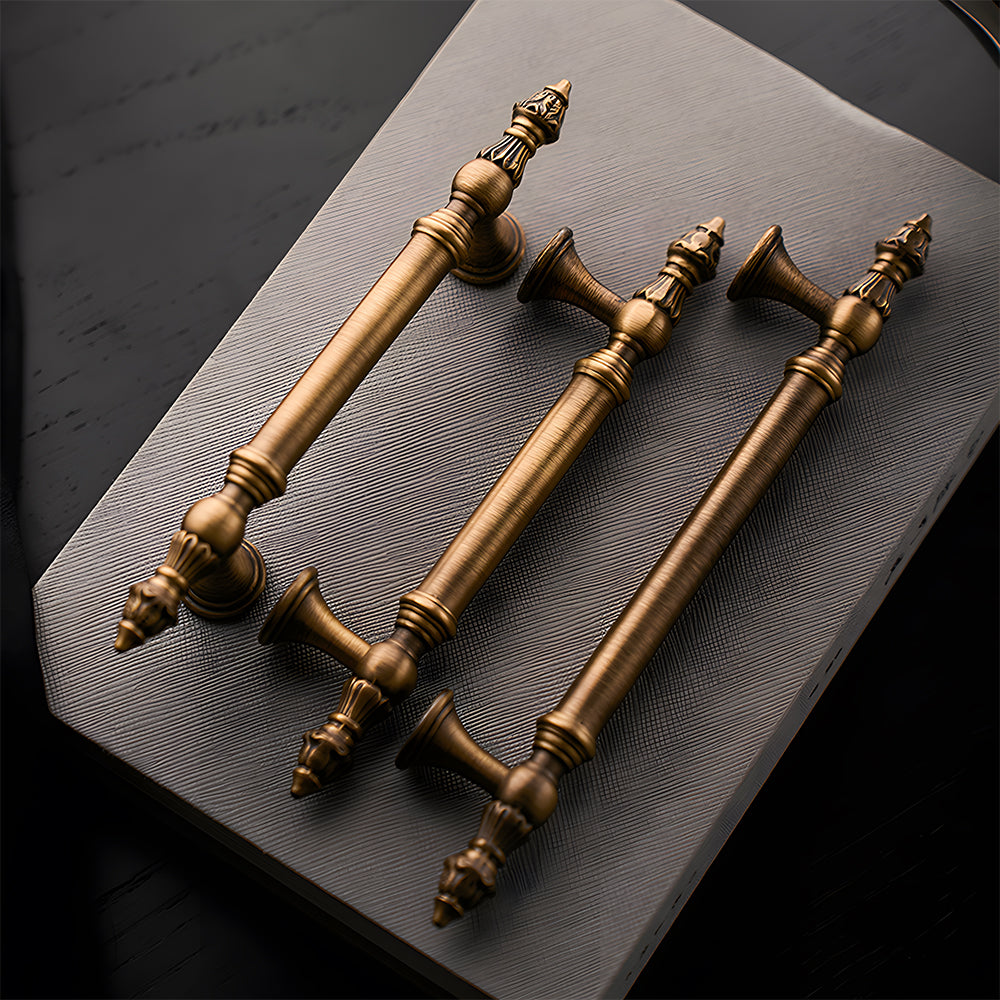 Ornate european brass cabinet pull and round knobs, shown clearly with related hardware in one display