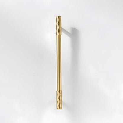 Gold faceted brass cabinet pull and round knob, shown from one angle on a clean neutral background