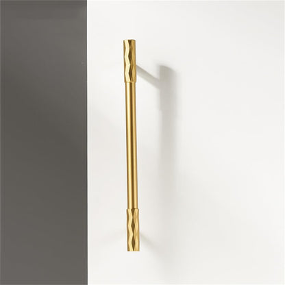 Gold faceted brass cabinet pull and round knob, pictured in one view on a clean neutral background