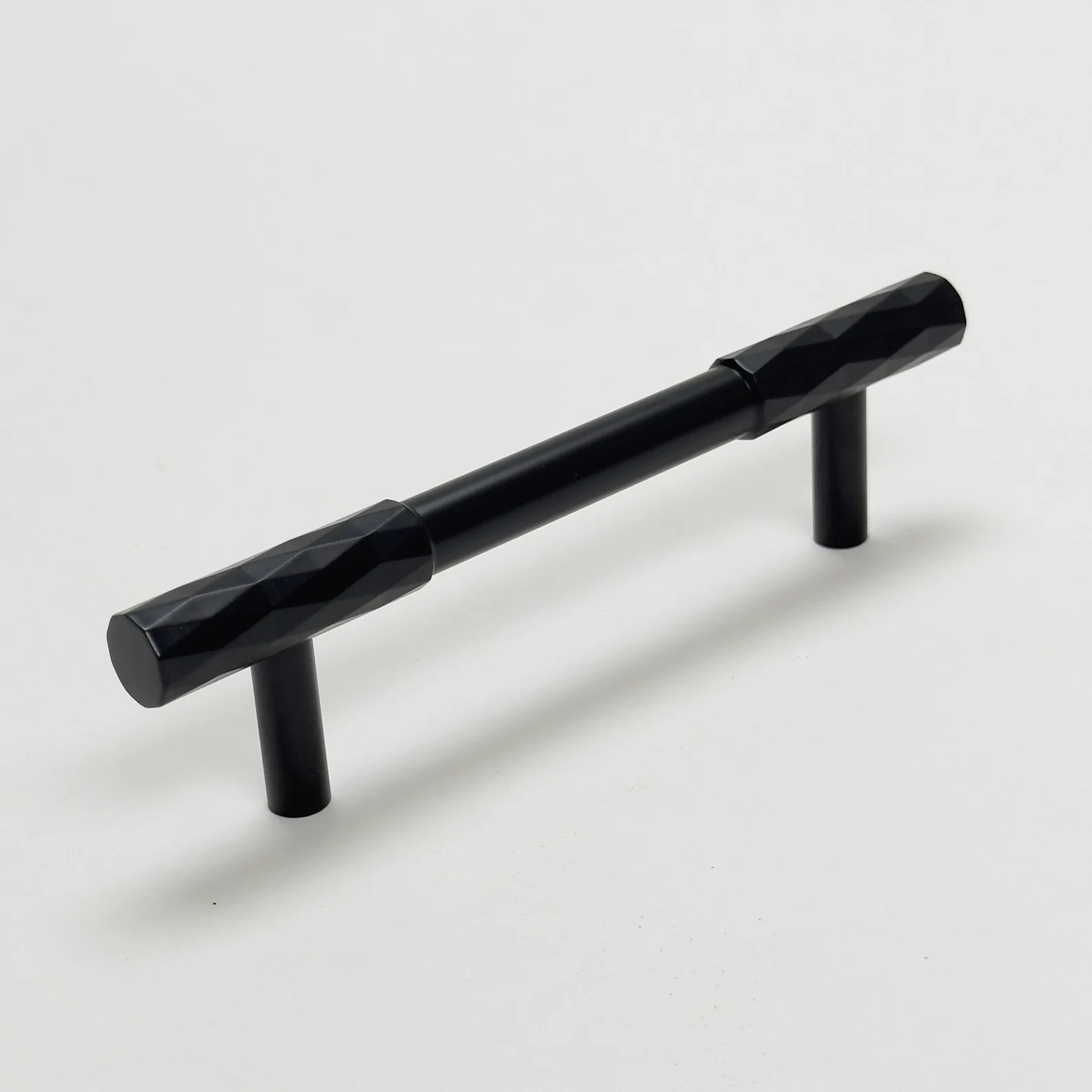 Faceted brass cabinet pull and round knob, presented in another view on a clean neutral background