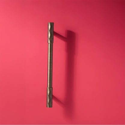 Bronze faceted brass cabinet pull and round knob, shown clearly on a clean neutral background