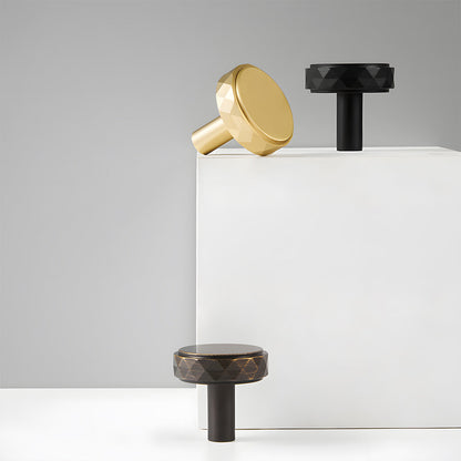 Faceted brass cabinet pull and round knob, shown at close range as a color and finish lineup