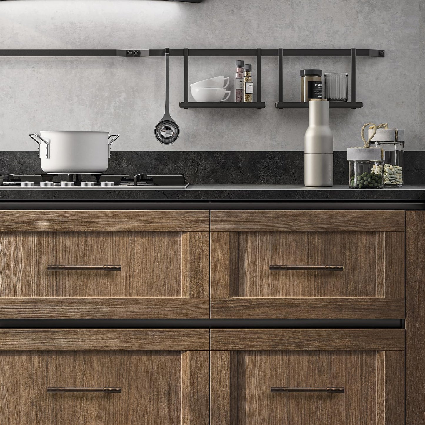 Bronze faceted brass cabinet pull and round knob, shown at close range installed on cabinetry in context