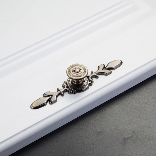 Bronze round cabinet knob with ornate floral backplate, pictured in one view on a clean neutral background