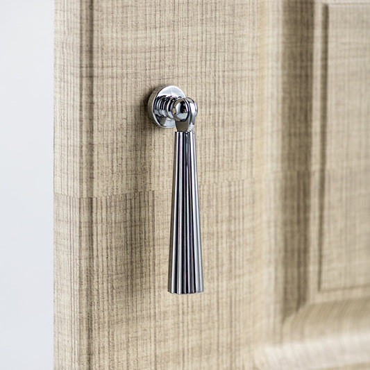Silver fluted pendant drop pull, shown from one angle in an installed cabinet close-up