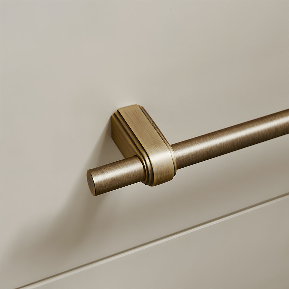 French brass round bar cabinet pull with block mounts, shown clearly with its construction and finish visible