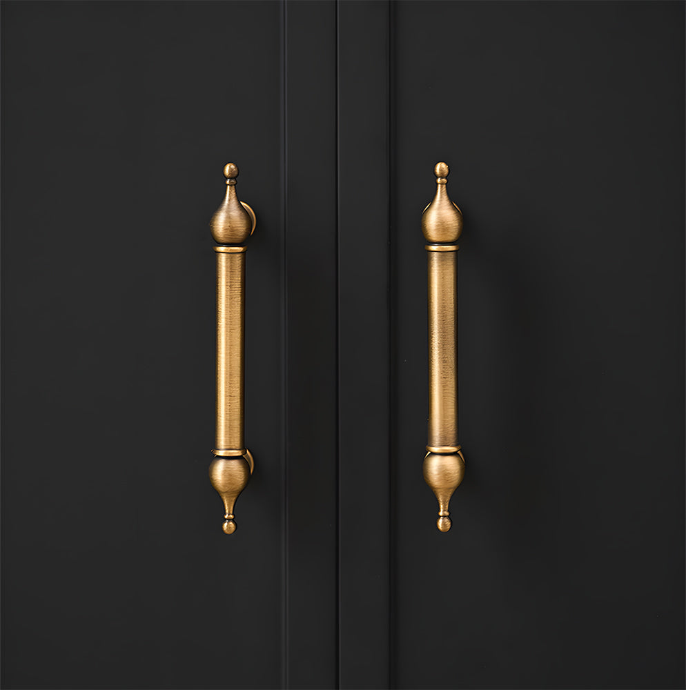 French retro turned brass cabinet pull and spindle knob, shown clearly installed on cabinetry in context