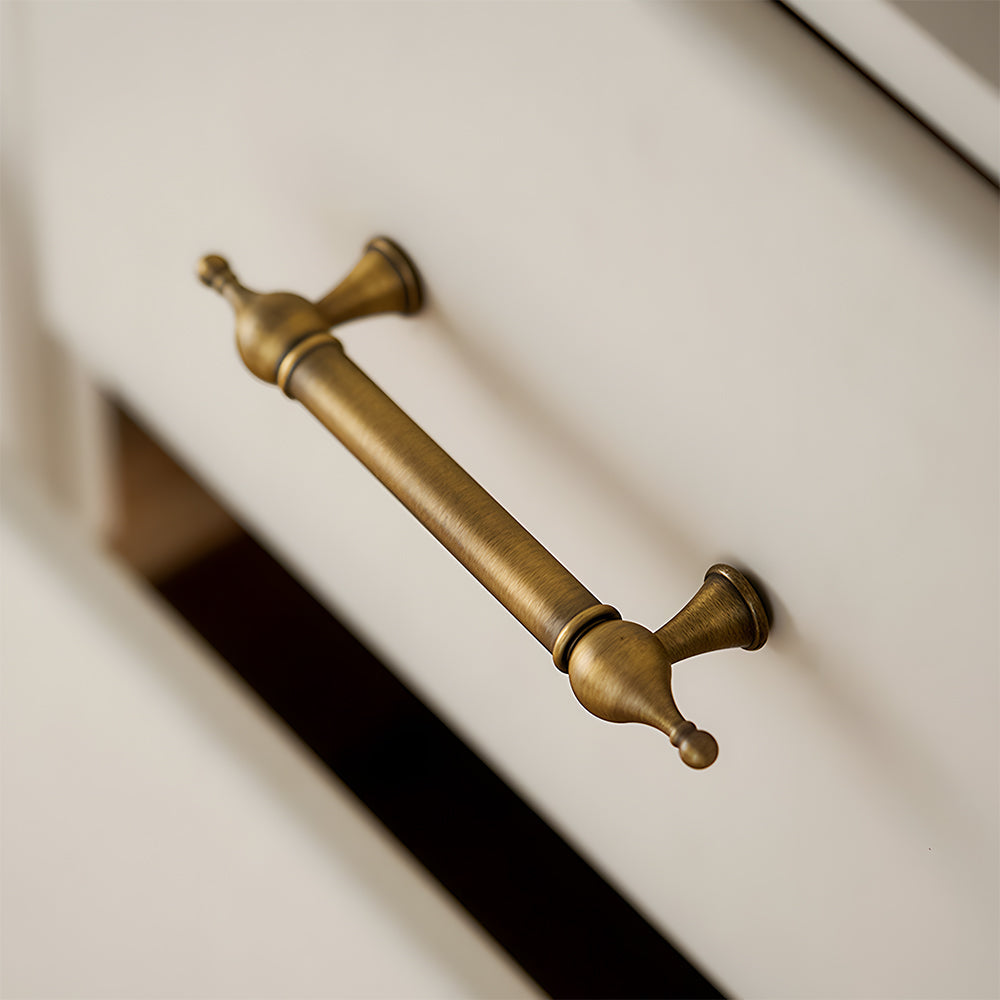 French retro turned brass cabinet pull and spindle knob, displayed from the side installed on cabinetry in context