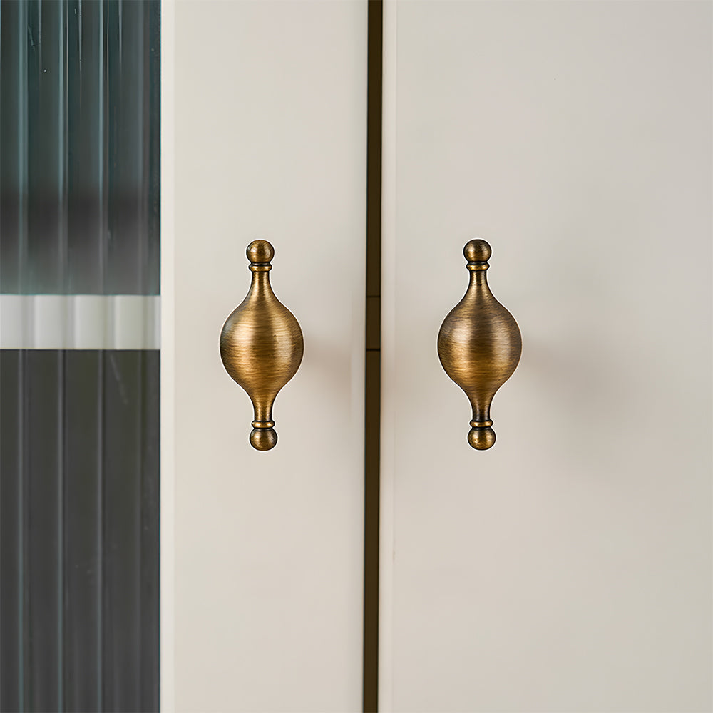 French retro turned brass cabinet pull and spindle knob, shown in a focused view installed on cabinetry in context