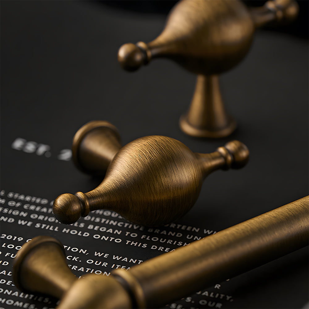 French retro turned brass cabinet pull and spindle knob, shown at close range in an installed cabinet close-up