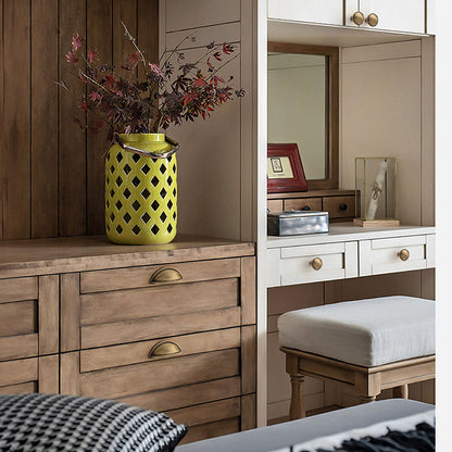 Half-round brass cabinet cup pull, presented for reference installed on cabinetry in context