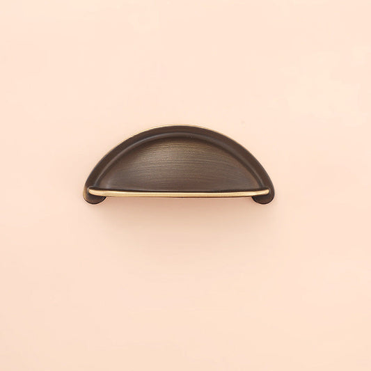 Half-round brass cabinet cup pull, shown from one angle on a clean neutral background
