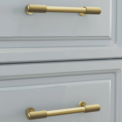 Knurled brass round bar cabinet pull, shown clearly installed on cabinetry in context
