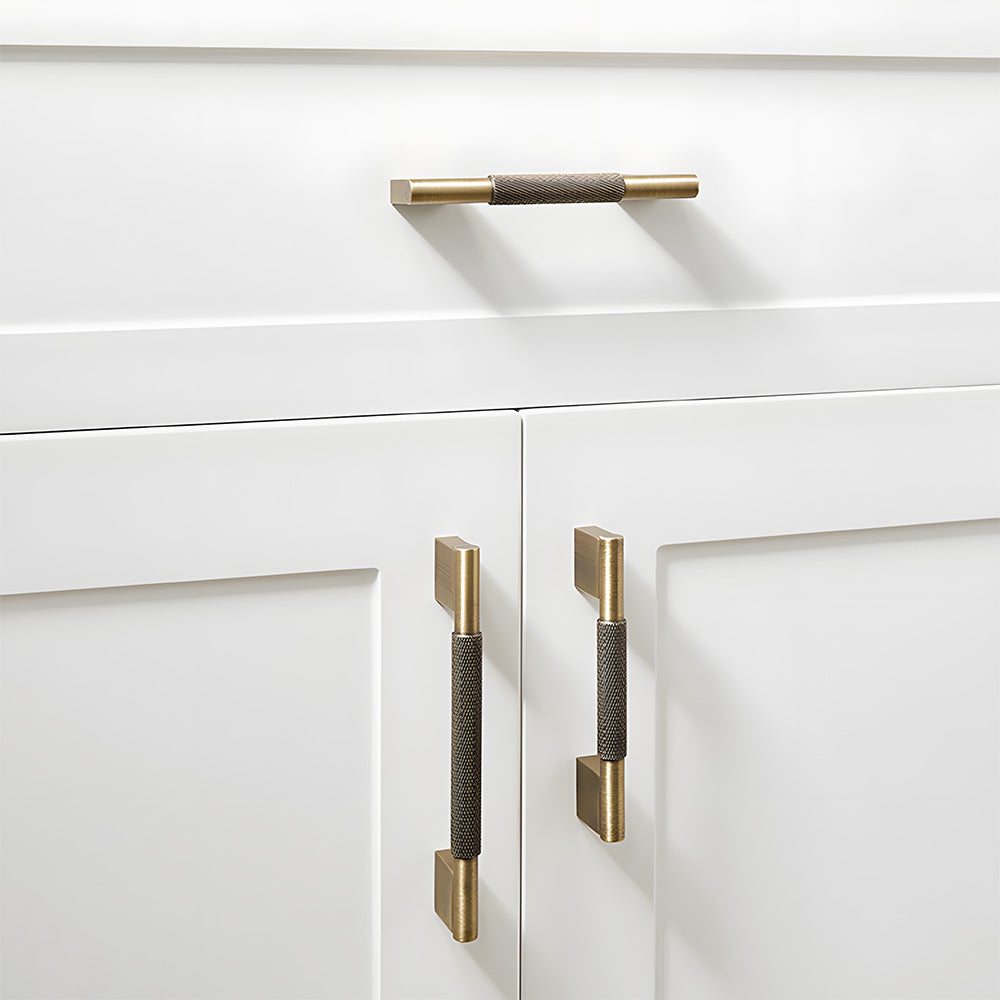 Knurled brass cabinet pull with rectangular mounts and knob, presented in another view installed on cabinetry in context