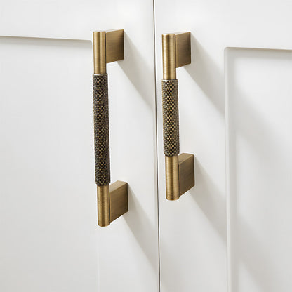 Knurled brass cabinet pull with rectangular mounts and knob, shown clearly mounted on a finished cabinet front