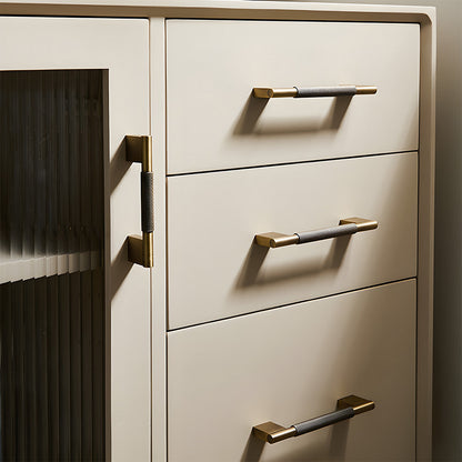 Knurled brass cabinet pull with rectangular mounts and knob, shown from one angle installed on cabinetry in context