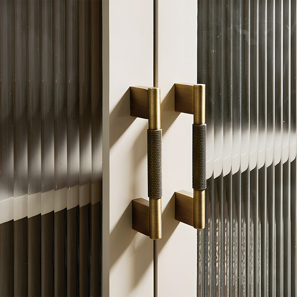 Knurled brass cabinet pull with rectangular mounts and knob, pictured in one view installed on cabinetry in context