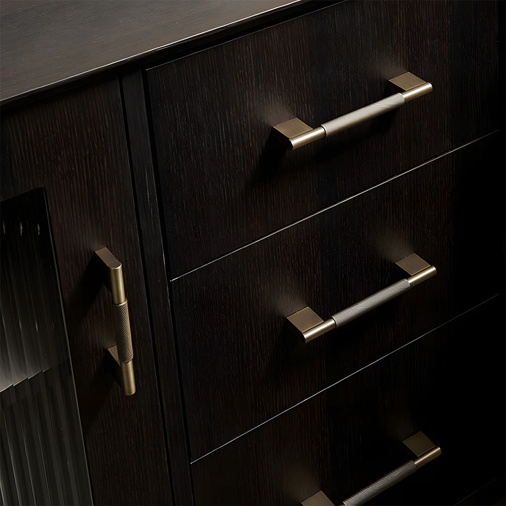 Knurled brass cabinet pull with rectangular mounts and knob, displayed from the side installed on cabinetry in context