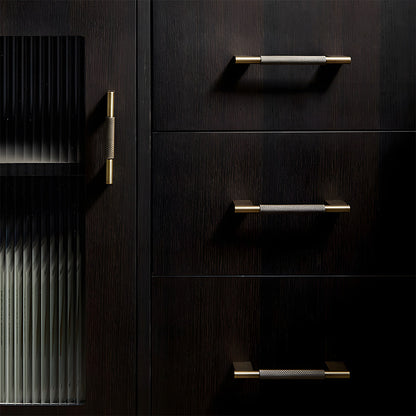 Knurled brass cabinet pull with rectangular mounts and knob, shown in a focused view installed on cabinetry in context