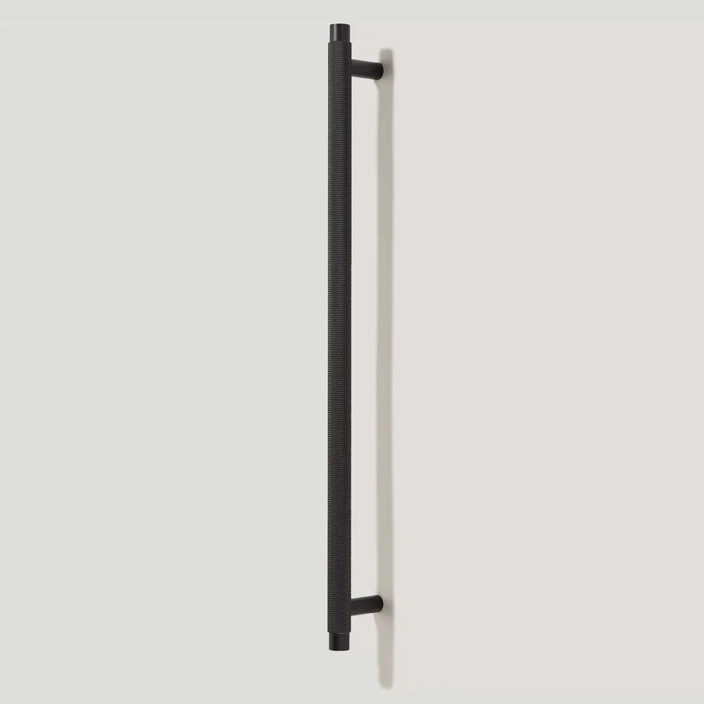 Black knurled T-bar cabinet pull, presented in another view on a clean neutral background