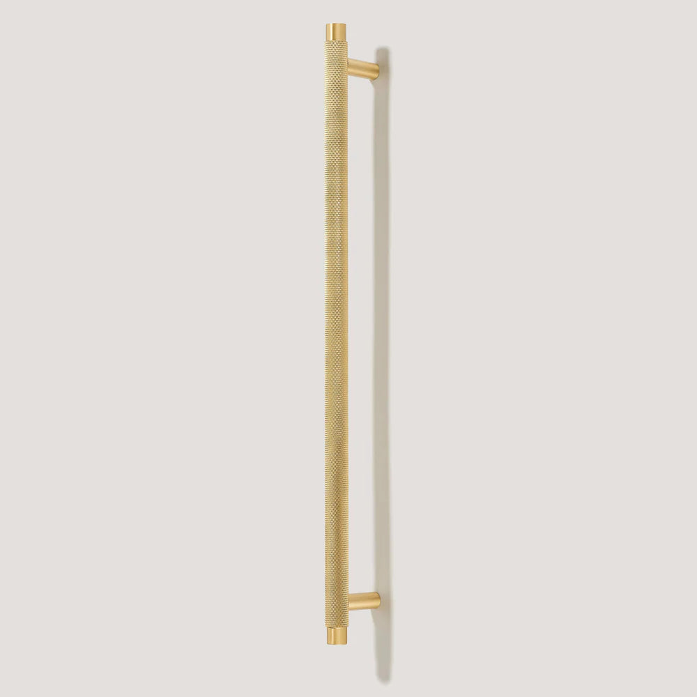 Gold knurled T-bar cabinet pull, presented for reference on a clean neutral background